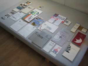 Printed brochures and portfolio materials spread out